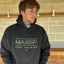 Person wearing a black hoodie with 'MAXBP Fast Training' text against a brick wall.